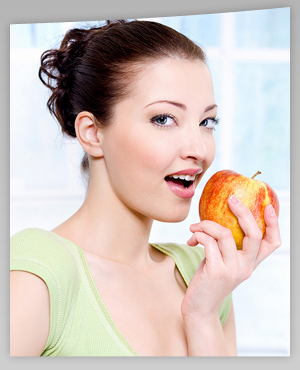 photo of woman eating apple